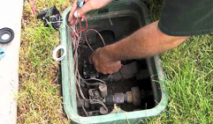 Replacing wiring in a valve box during a sprinkler repair in Carrollton Texas